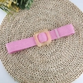 Close-up of pink elastic woven belt featuring a square transparent resin buckle - Pink