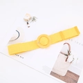 Detail of yellow straw woven waist belt with round buckle on a magazine page - Round Buckle / Yellow