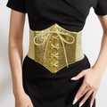 Women's gold glitter elastic corset belt with lace-up front over black dress - Gold