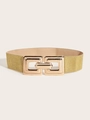 Macro detail of elastic gold woven waist belt featuring a geometric square metal buckle - Gold