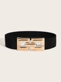 Detailed view of wide elastic waist belt featuring a gold geometric interlocking buckle - Black