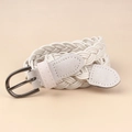 Detail shot of a cream woven elastic belt with a dark metal pin buckle and matte finish cap - White