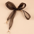Detail of coffee organza bow belt featuring white stitching and pearl pendants - Black Ribbon Style