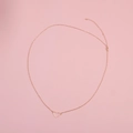 Detail of rose gold heart pendant on a delicate metal chain over a pink background - Hollow Heart Style (006) / Gold