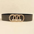 Detail of the golden interlocking triple-ring buckle on a black elastic waist belt - Pearl Black Gold
