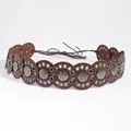 Detail of bohemian waist belt featuring circular brown leather with silver embossed metal - 817 Gun Black Red Brown