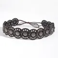 Detail of bohemian retro waist belt featuring brown leather discs and embossed metal studs - Gun Black Coffee