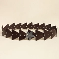 Close-up of vintage Y2K belt featuring brown leather triangles and a silver star buckle - Coffee