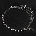 Chaîne de taille multicouche en perles avec pendentif coquillage sur fond noir mat - Argenté
