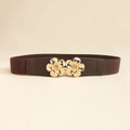 Detail view of elastic waist belt featuring dual 3D golden flower metal buckles for women - Coffee Gold