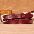 Slim burgundy leather belt for women featuring continuous floral and leaf embossed details - Red