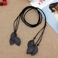 Handwoven black belt with silver leaf charms and wooden beads on beige texture - Black