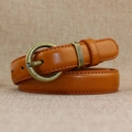 Vintage brown leather slim belt for women featuring a bronze round buckle and fine stitching - Camel