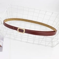 Slim reddish-brown leather belt for women featuring a matte golden oval buckle detail - Red Brown