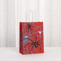 Detailed close-up of red Halloween spider gift bag with twisted paper handles and web print - Bright Red Spider Print (451-2) / 21*15*8
