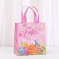 Detailed view of pink non-woven Easter gift bag featuring Happy Easter text and egg patterns - Pink