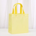 Detail of light yellow non-woven tote bag with reinforced stitching and textured finish - 23*22*11 / Macaron Yellow