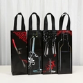 Set of four black non-woven wine gift bags with artistic wine bottle and glass prints - Wine Culture Print Style