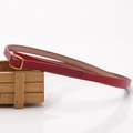 Deep red leather belt with vintage golden alloy square buckle displayed on a wooden box - Red