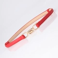 Slim red waist belt for women with interlocking gold metal buckle on white reflective surface - Red