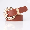 Women's brown leather belt featuring a textured strap and a sculptural gold crescent buckle - Camel