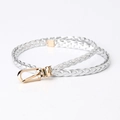Women's woven skinny belt featuring a silver braided strap and golden horseshoe buckle - Silver