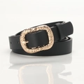 Women's black leather slim belt with a vintage engraved gold buckle on white background - Black