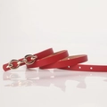 Slim red women's fashion belt featuring a polished gold double ring buckle and textured finish - Red