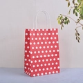Red paper gift bag with white polka dots and durable twisted handles for packaging - Red / 15x11x6cm