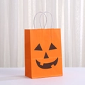 Halloween orange kraft paper gift bag with black pumpkin face and white handles - Orange Pumpkin Face Vertical (339-7)