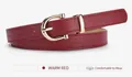Macro detail of slim warm red leather belt with horseshoe shaped golden metal buckle - Burgundy / 105*1.8