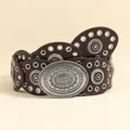 Close-up of vintage brown leather belt with large embossed western alloy buckle - Antique Silver Coffee