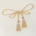 Close-up of woven waist rope with gold beads and fringe tassels on a textured surface - Cream & White Dual Tone