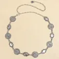 Detail of silver vintage metal waist chain with rose pendant and textured geometric links - Antique Silver