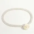 Elegante cintura a due fili di perle con fiore di camelia bianca su sfondo bianco - Bianco