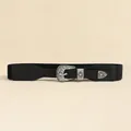 Detail of western vintage carved buckle and star motif on black elastic waist belt - Black / 81cm