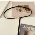 Detail of slim black leather belt with minimalist golden metal buckle on magazine background - 108cm / Black