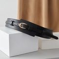 Close-up of black wide leather waist belt with gold horseshoe buckle on white props - Black / Regular Size 80/102cm