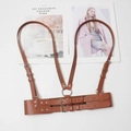 Close-up of brown PU leather body harness with silver buckles and double-row buttons - Brown