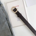 Close-up of a minimalist dark brown belt with a vintage golden oval metal buckle - Coffee