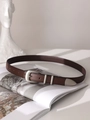 Detail of dark brown leather belt with matte silver buckle and vintage metal tip accents - Coffee