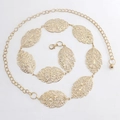 Detail of golden metal waist chain featuring hollow leaf charms and adjustable lobster clasp - Gold