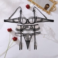 Completo intimo in pizzo floreale nero con fiocco e reggicalze su un morbido tessuto bianco - S / Nero