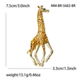 Elegant gold giraffe brooch with brown enamel spots and a green zircon eye on white background - Brown