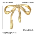 Elegant golden alloy ribbon bow brooch with polished finish and secure safety pin back - Gold