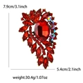 Vintage gold alloy brooch with red oval stone and rhinestones on a white background - Red