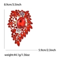 Detail showing dimensions of red rhinestone brooch with gold setting and large central gem - Red