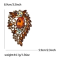 Vintage large gold alloy brooch with amber glass stones, measuring 3.5 by 2.3 inches - Brown