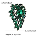 Detail view of a vintage green rhinestone brooch with dimensions 7.9cm by 5.4cm - Green
