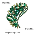 Green crystal leaf brooch in gold finish with 9.1cm length and 43.6g weight - Green